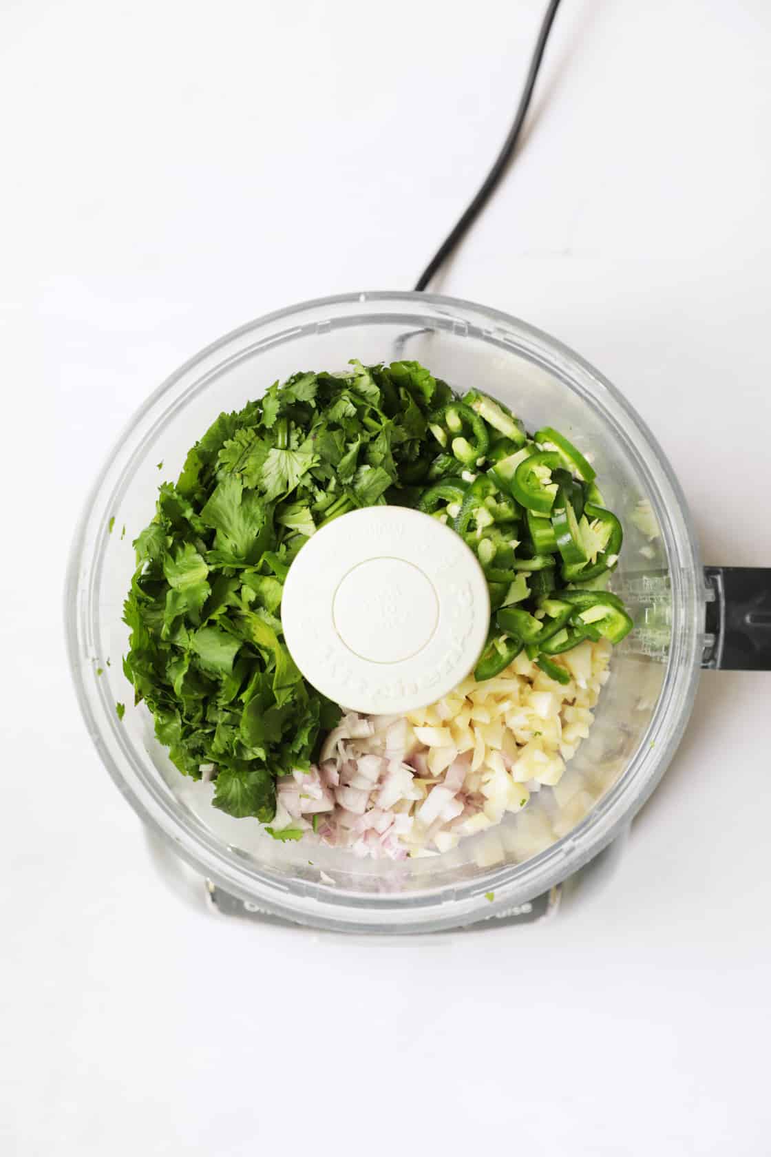 Photo of ingredients for green curry in mini food processor before being pureed.