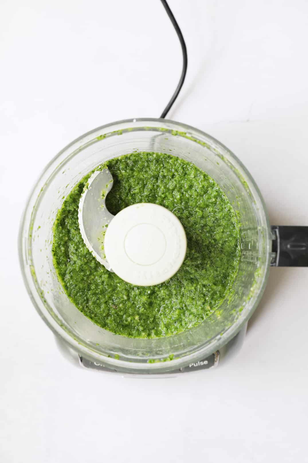 Photo of green curry in mini food processor after processing.