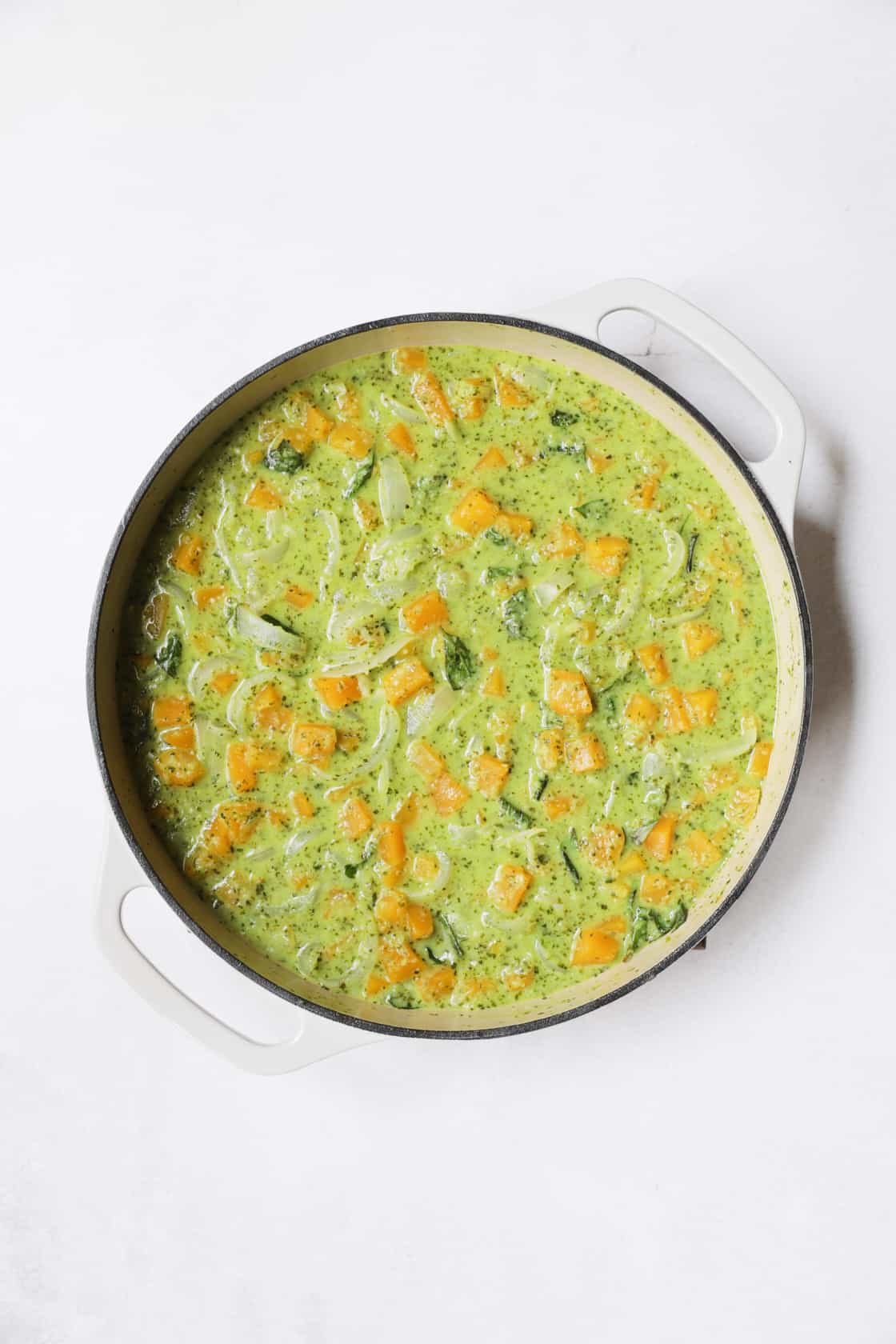 Photo of completed butternut squash curry in white pan.