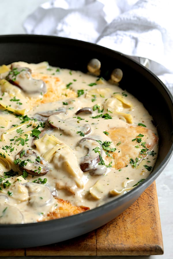 Turkey Scallopini in Sherry Cream Sauce with Mushrooms and Artichoke Hearts - Straight-on close-up shot of dish in skillet