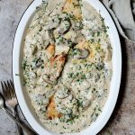 Turkey Scallopini in Sherry Cream Sauce with Mushrooms and Artichokes - Overhead shot of finished dish on white platter