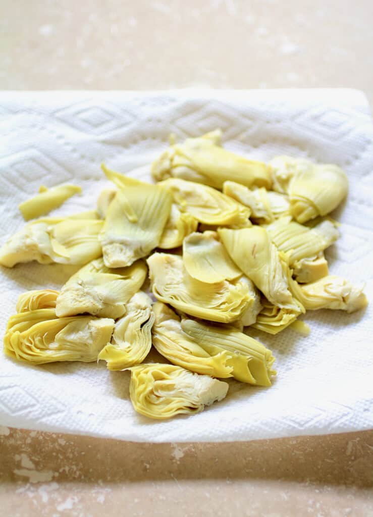 Photo of artichokes being dried on paper towel.
