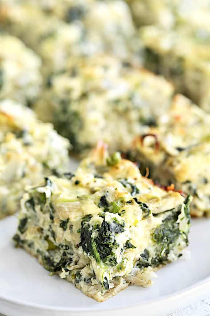 Close-up photo of one Spinach Artichoke Square.