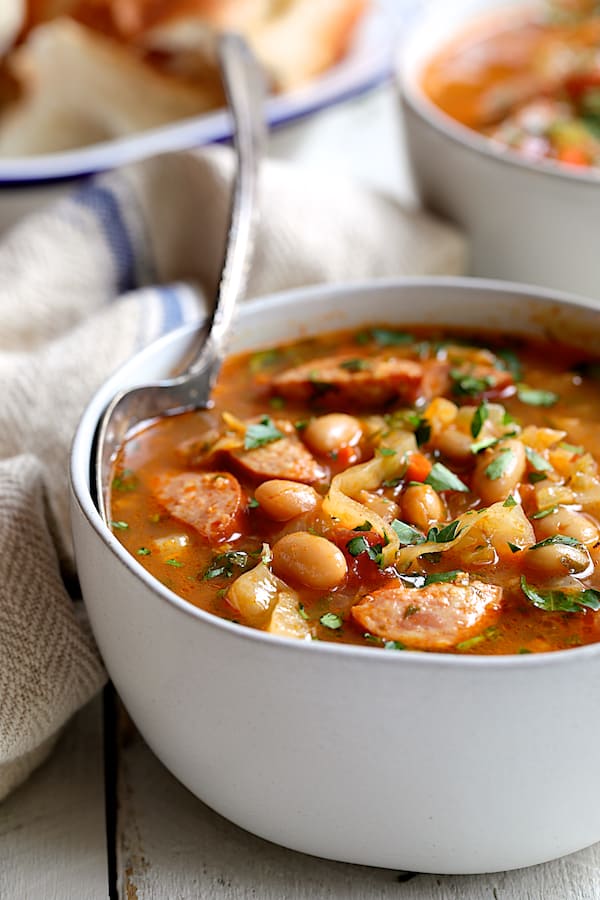 Close-up photo of one serving of Farmhouse Cabbage Soup with Cannellini Beans and Kielbasa.