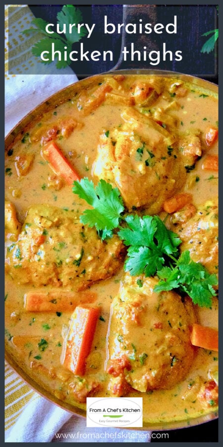 Four Curry Braised Chicken Thighs in skillet garnished with cilantro.