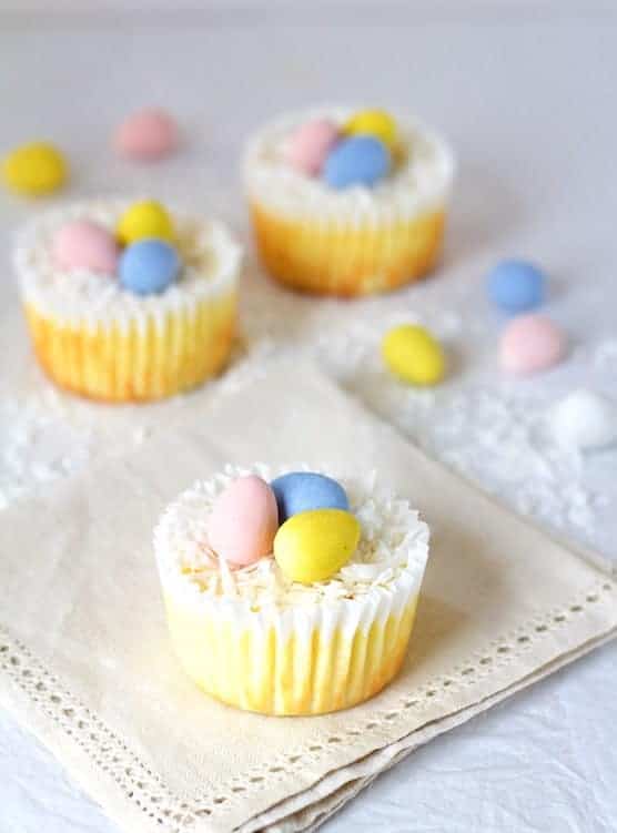 Three Mini Cheesecakes decorated with coconut and candy robin eggs.