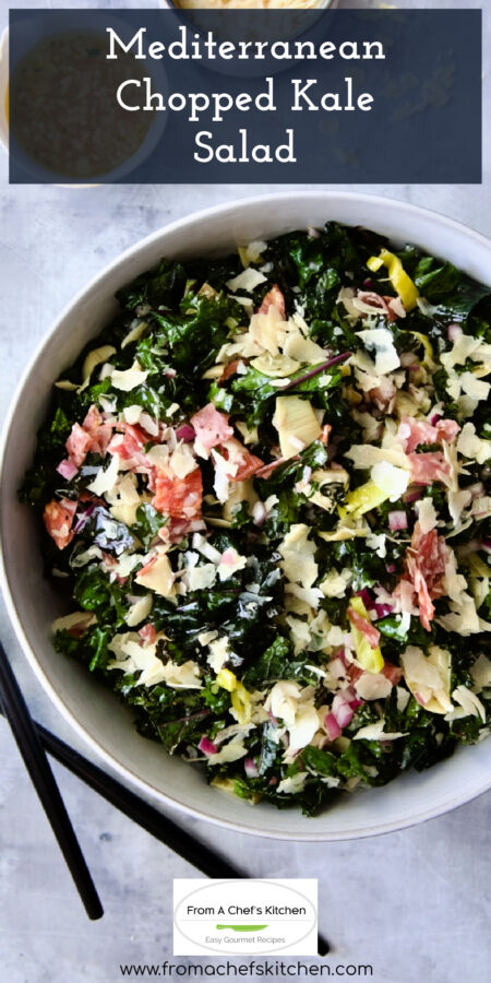 Pinterest graphic for Mediterranean Chopped Kale Salad showing it in a white bowl with black utensils.