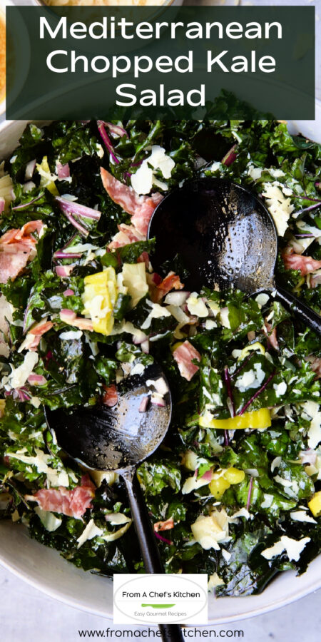 Pinterest graphic for Mediterranean Chopped Kale Salad showing it in a white bowl with black utensils.