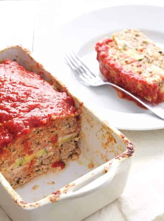 Layered Turkey Meatloaf with Roasted Red Pepper and Balsamic Glaze with pieces removed to expose filling.