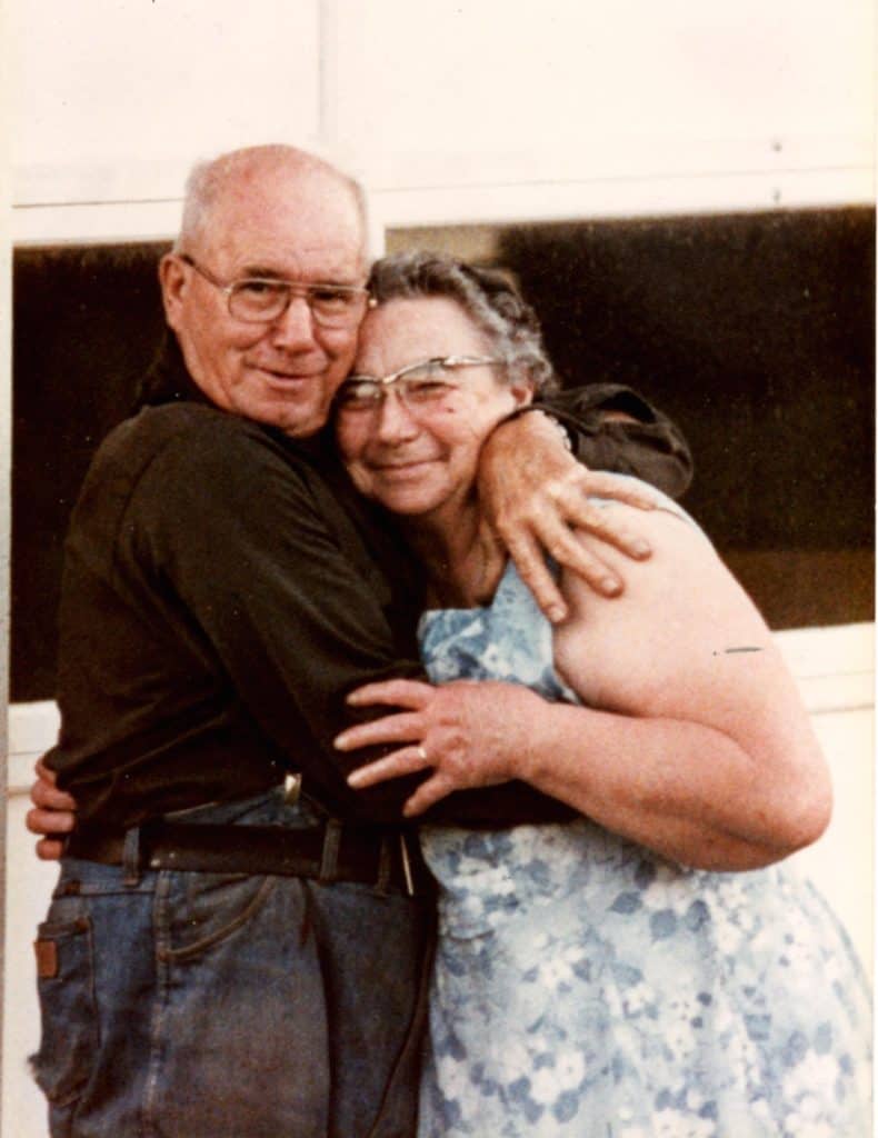 Photo of an elderly couple embracing.