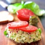 Tofu Salad on slice of bread topped with tomato slices.