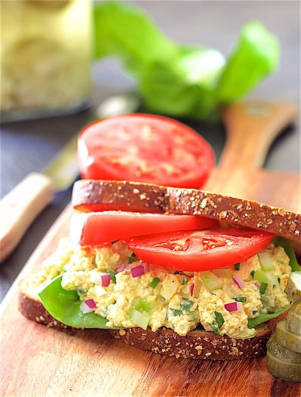 Photo of Curried Tofu Salad on whole grain bread with lettuce and tomato.
