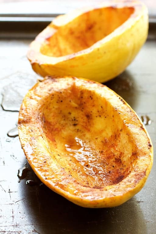 Photo of roasted spaghetti squash halves on baking sheet.