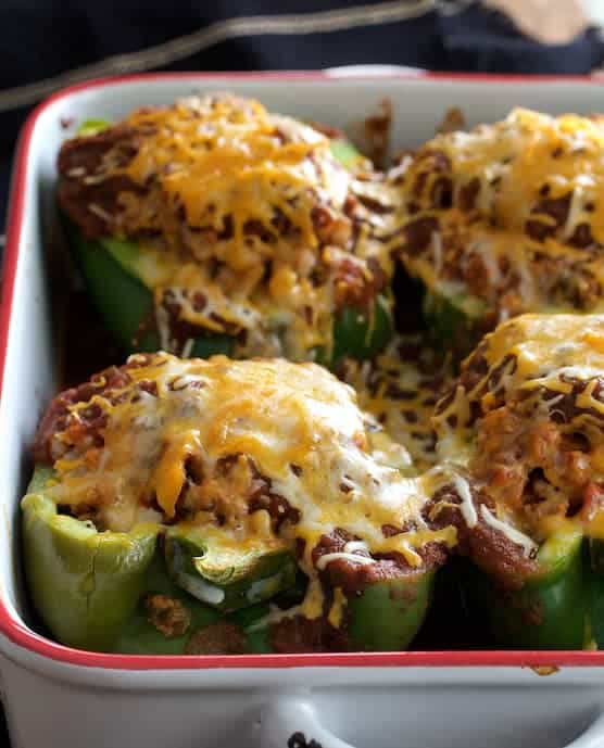 Photo of Southwestern Beef and Barley-Stuffed Bell Peppers in white baking dish.
