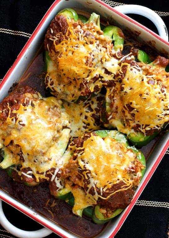 Southwestern Beef and Barley-Stuffed Bell Peppers in red-rimmed white baking dish.