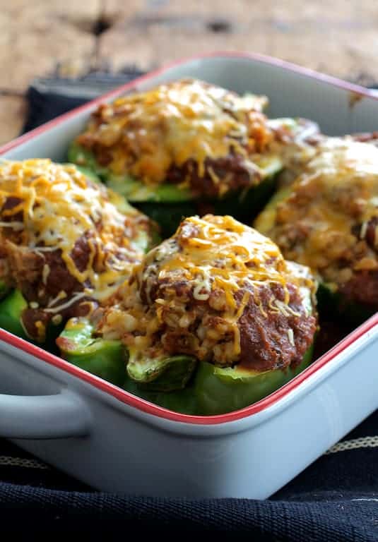 Photo of Southwestern Beef and Barley-Stuffed Bell Peppers in white baking dish.