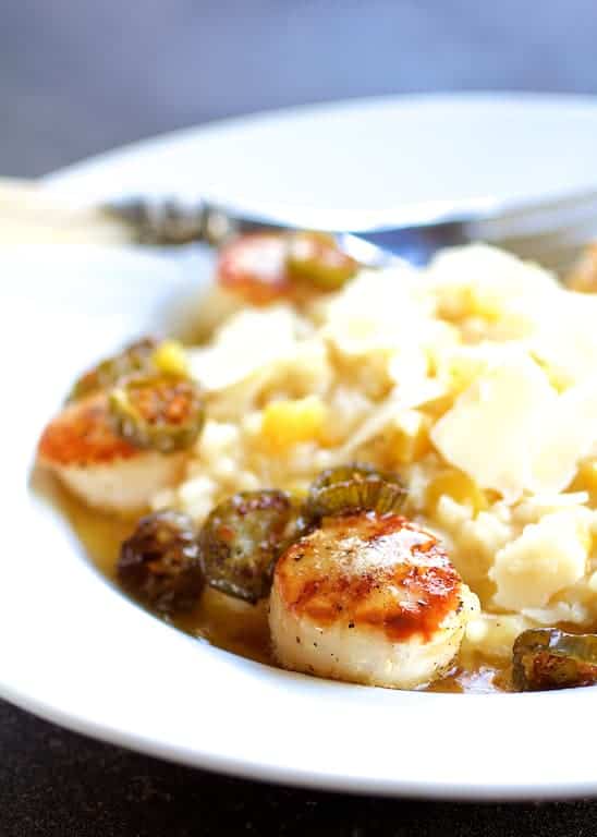 Photo of Seared Scallops with Jalapeño Browned Butter and Mango Buttermilk Risotto on white plate.