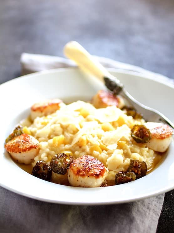 Photo of Seared Scallops with Jalapeño Browned Butter and Mango Buttermilk Risotto on white plate with decorative fork.