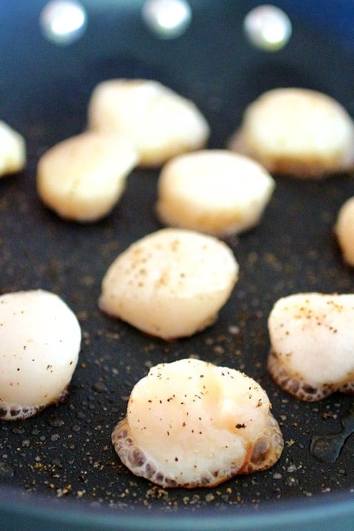 Photo of sea scallops being seared in nonstick skillet.