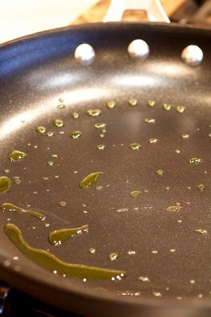 Photo showing oil being heated in a nonstick skillet.