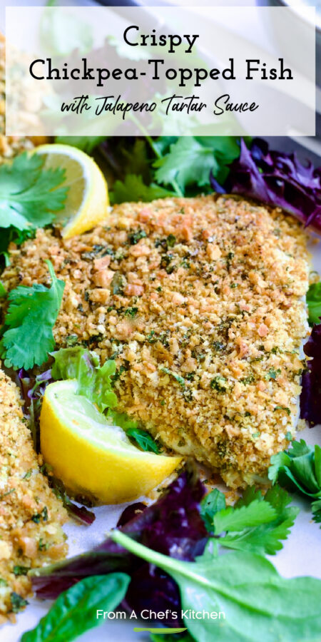 Pinterest graphic for Crispy Chickpea-Topped Fish with Jalapeno Tartar Sauce showing it garnished with fresh lemons and baby greens.