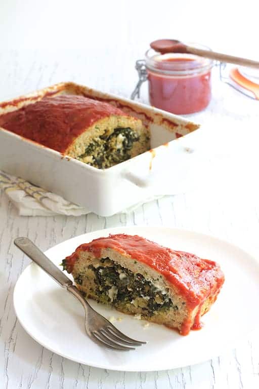 Photo of a piece of Spinach Feta Stuffed Turkey Meatloaf on white plate.