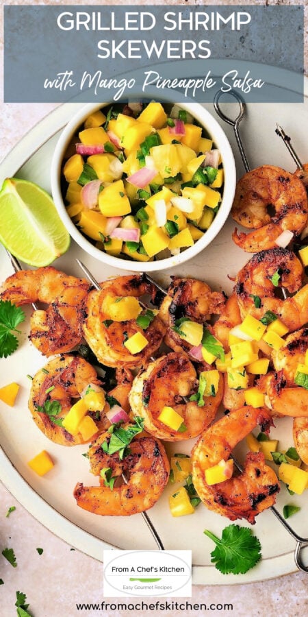 Pinterest graphic for Grilled Shrimp Skewers with Mango Pineapple Salsa showing all the skewers on round white plate.