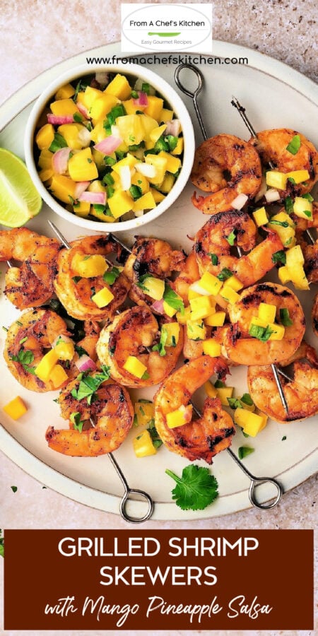 Pinterest graphic for Grilled Shrimp Skewers with Mango Pineapple Salsa showing all the skewers on round white plate.