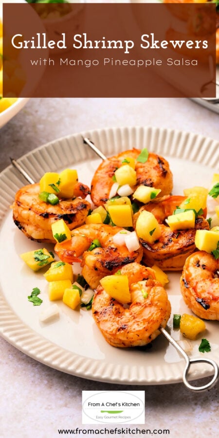 Pinterest graphic for Grilled Shrimp Skewers with Mango Pineapple Salsa showing two skewers of three shrimp each on white plate.
