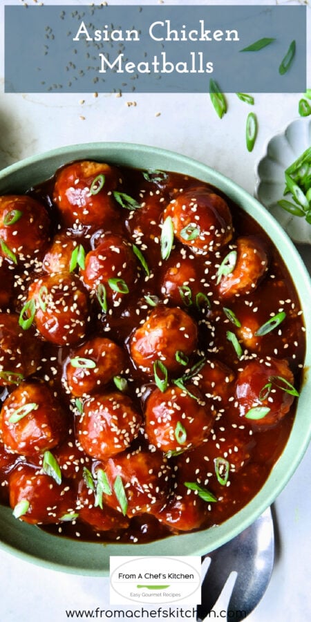 Pinterest graphic for Asian Chicken Meatballs showing them in a sage green serving bowl garnished with scallions and sesame seeds.