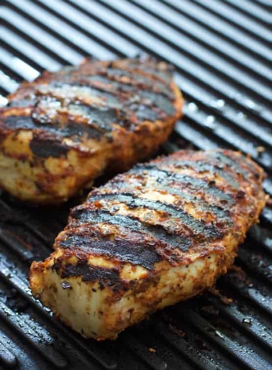 Photo of grilled blackened chicken breasts on grill pan.