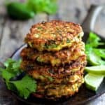 Stack of four Whole Grain Zucchini Jalapeno Fritters on small cast iron skillet.