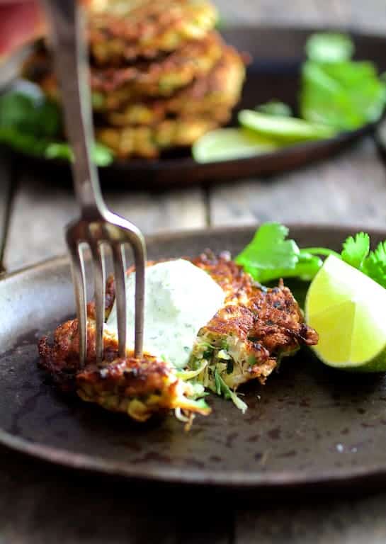 Photo of fritters with a fork digging into one.