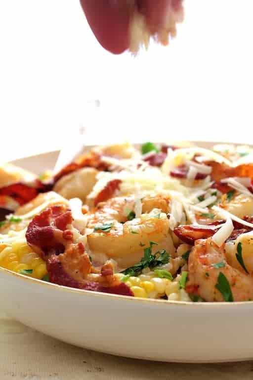 Photo of Shrimp and Corn Risotto with Bacon being sprinkled with cheese.