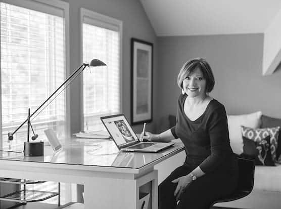 Carol Borchardt sitting at a computer.