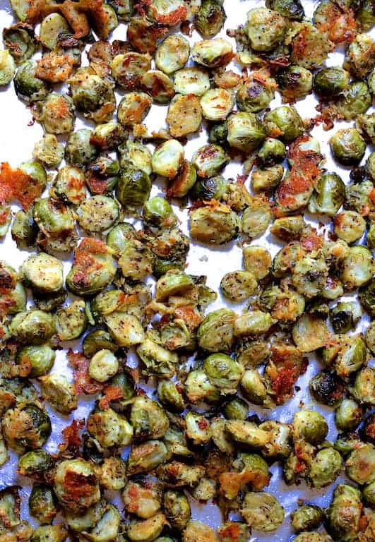 Photo of cooked Lemon Parmesan Crusted Brussels Sprouts on baking sheet.