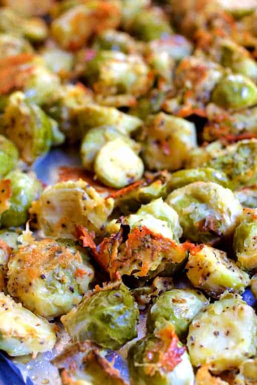 Close-up photo of Lemon Parmesan Crusted Brussels Sprouts on baking sheet after roasting.