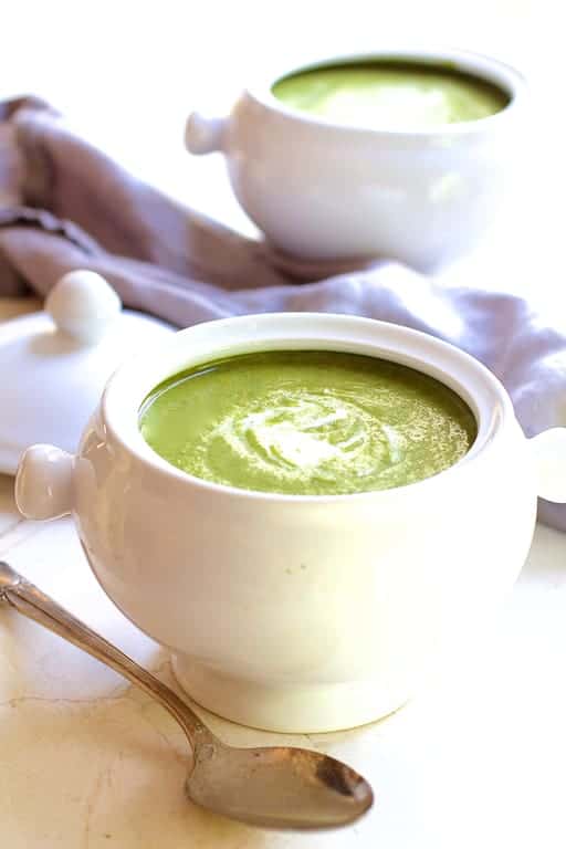 Photo of Cream of Green Vegetable Soup in white bowl with spoon.