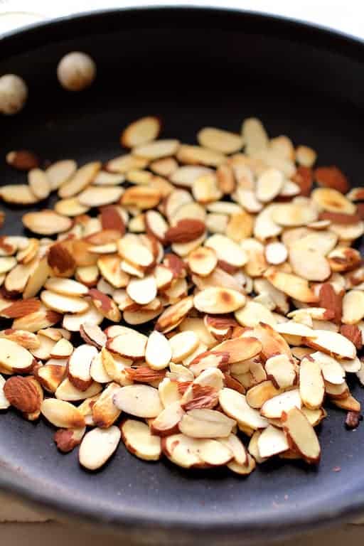 Photo of toasted almonds in nonstick skillet.