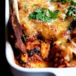 Mexican Chicken Tortilla Casserole in white baking dish with some removed.