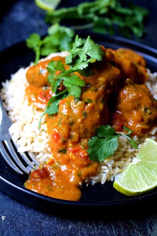 Close-up shot of meatballs over rice.