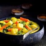 Indian Root Vegetable Curry in black bowl.