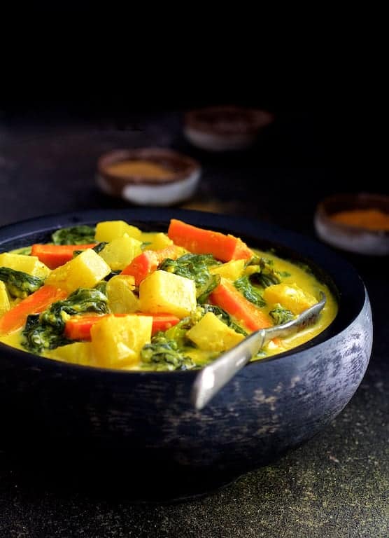 Indian Root Vegetable Curry in black bowl.