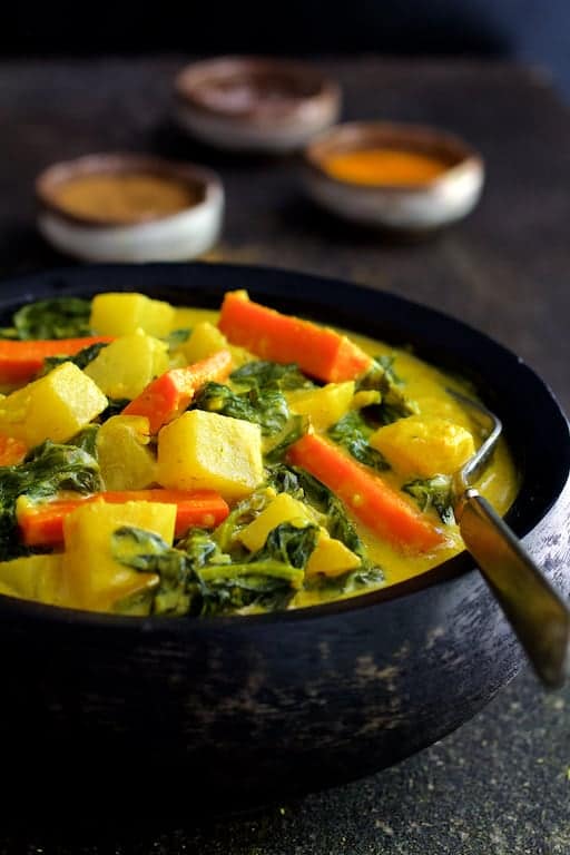 Close-up photo of Indian Root Vegetable Curry in black bowl.