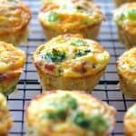 Twelve Spaghetti Squash Broccoli Bacon and Cheddar Mini Quiches on cooling rack.