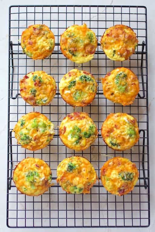 Photo of 12 Spaghetti Squash Broccoli Bacon and Cheddar Mini Quiche out of muffin pan on cooling rack.