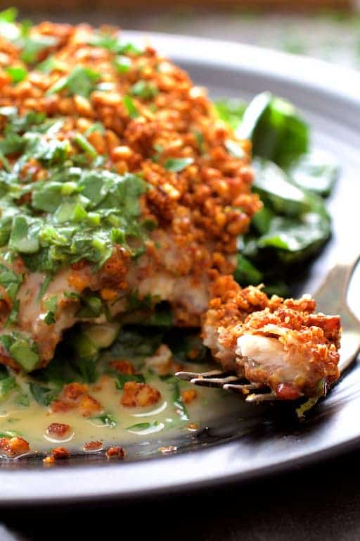 Photo of Baked Catfish Pecan Meuniere with a piece of fish on fork ready to be eaten.