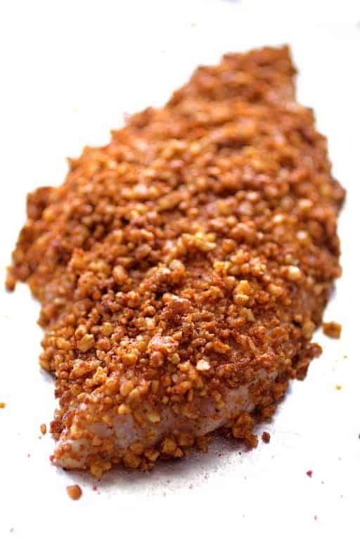 Photo of catfish fillet with pecan coating before being baked.