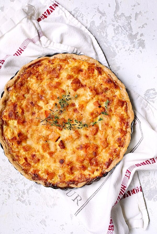 Whole Butternut Squash Leek and Gruyere Tart on French towel.