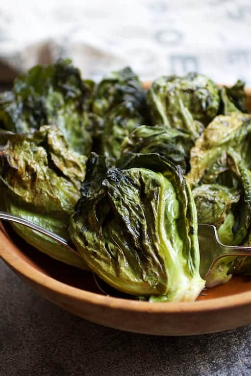Close-up photo of Duck Fat Roasted Cabbage Sprouts in wooden bowl.